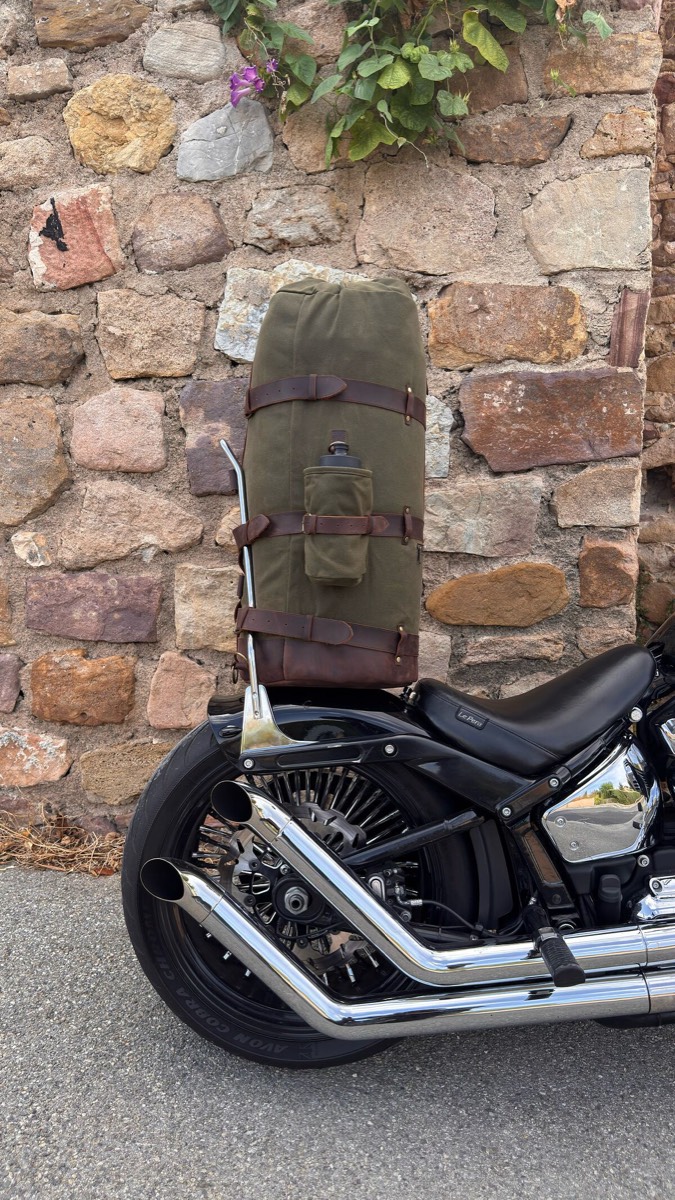 Rebel NPC waxed canvas duffle on a sissy bar